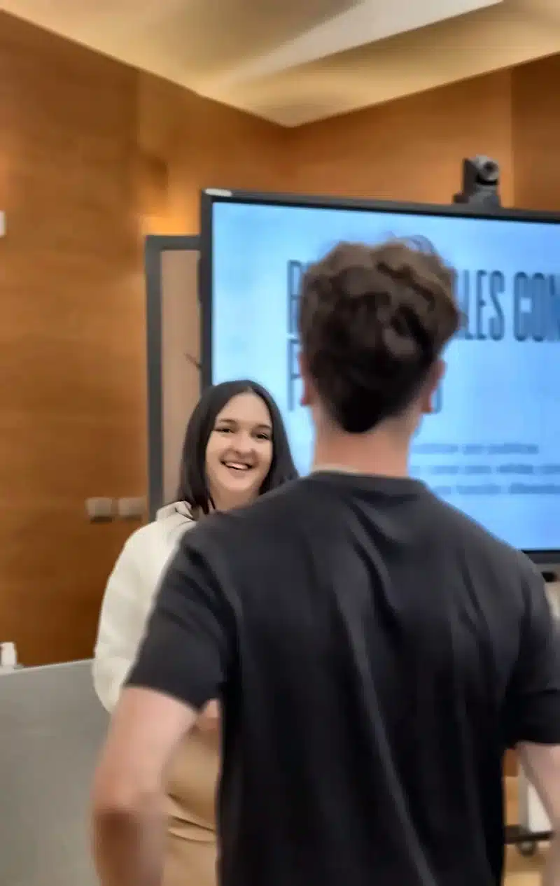 Oana Camaras sonriendo durante un taller de marketing mientras habla con un asistente