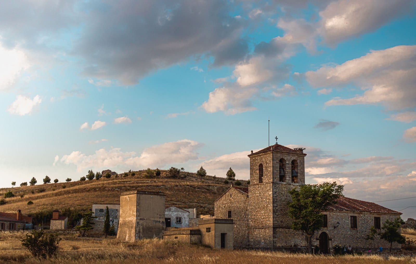 Pueblo del interior de España con iglesia de piedra al atardecer